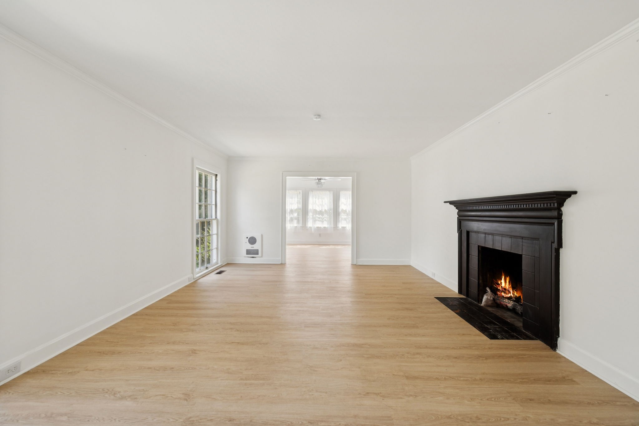 527 East Madison Street Pulaski, TN 38478 - Photo 23 of 74 a view of an empty room with wooden floor fireplace and a window