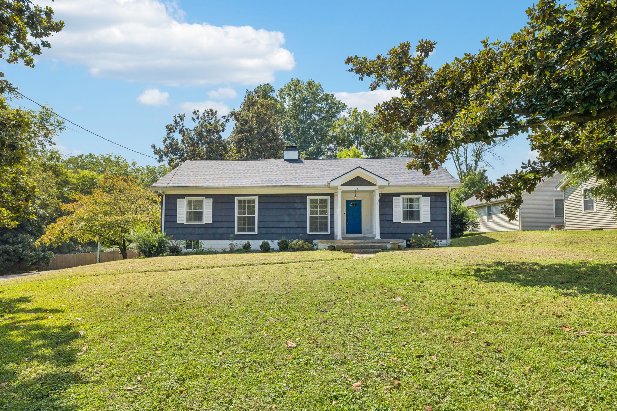 527 East Madison Street Pulaski, TN 38478 - Photo 3 of 74 a front view of a house with a garden