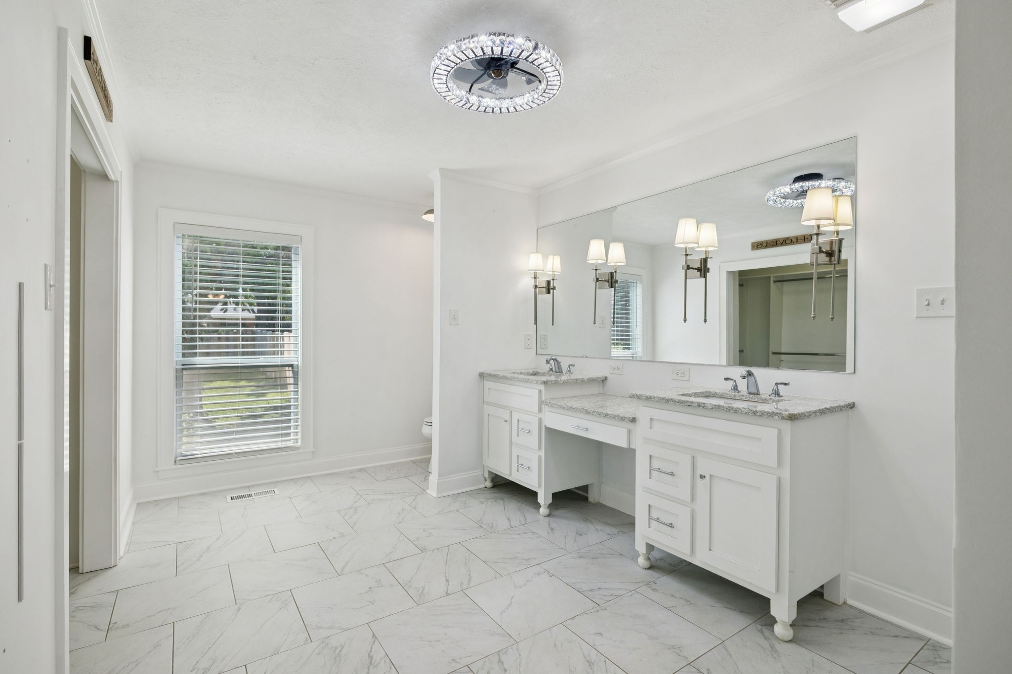 527 East Madison Street Pulaski, TN 38478 - Photo 31 of 74 a bathroom with a double vanity sink a mirror and a bathtub