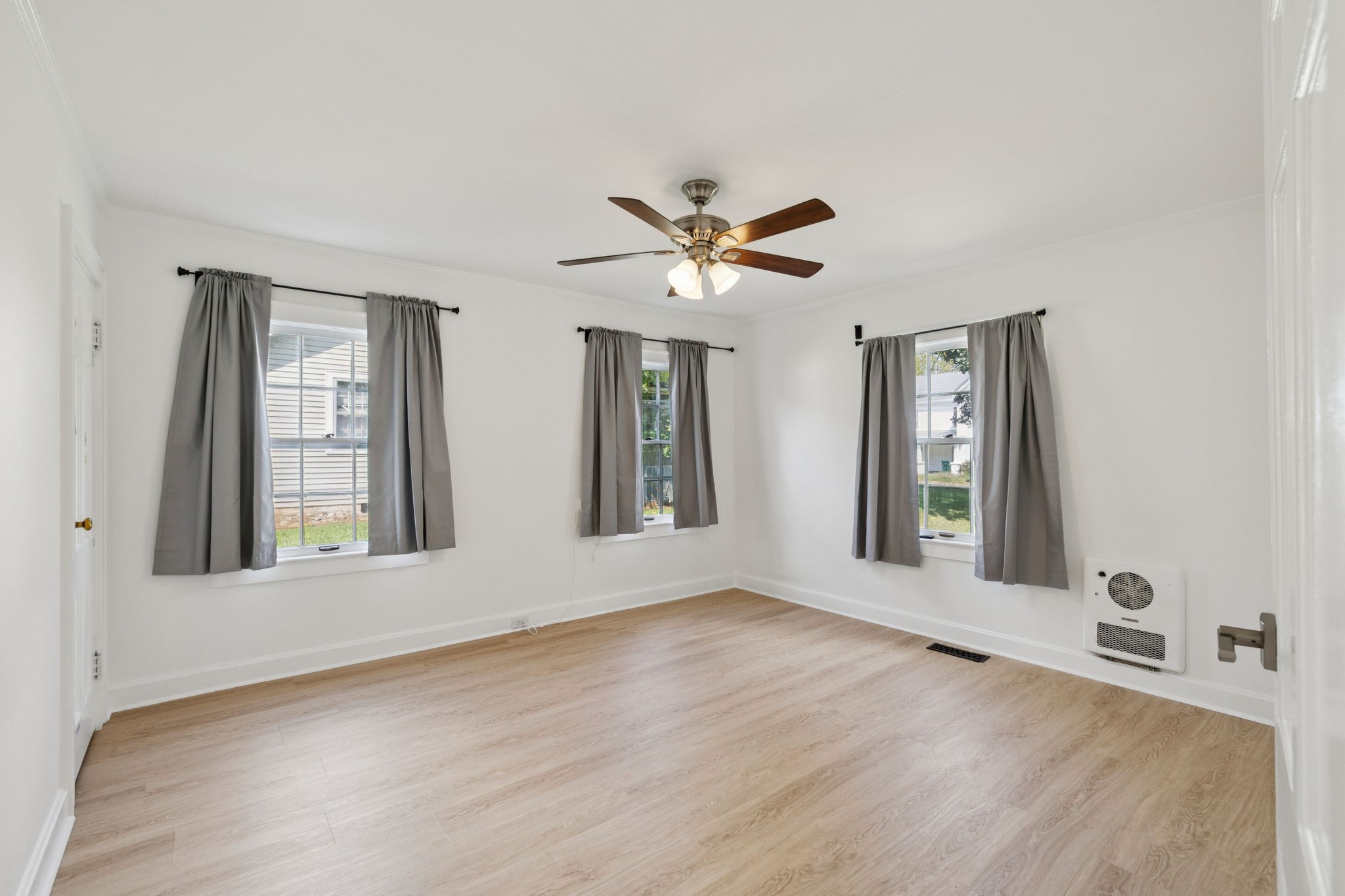 527 East Madison Street Pulaski, TN 38478 - Photo 37 of 74 a view of an empty room with window and wooden floor
