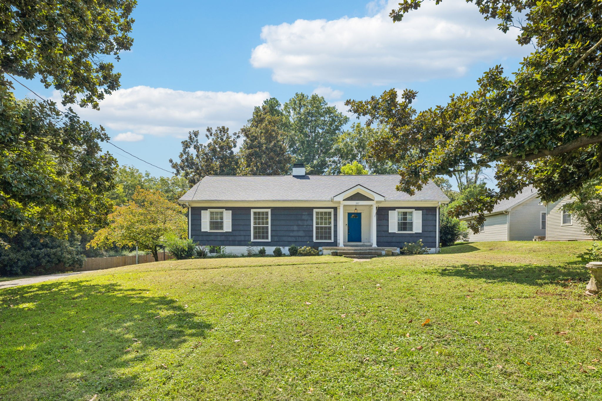 527 East Madison Street Pulaski, TN 38478 - Photo 4 of 74 a front view of a house with a garden