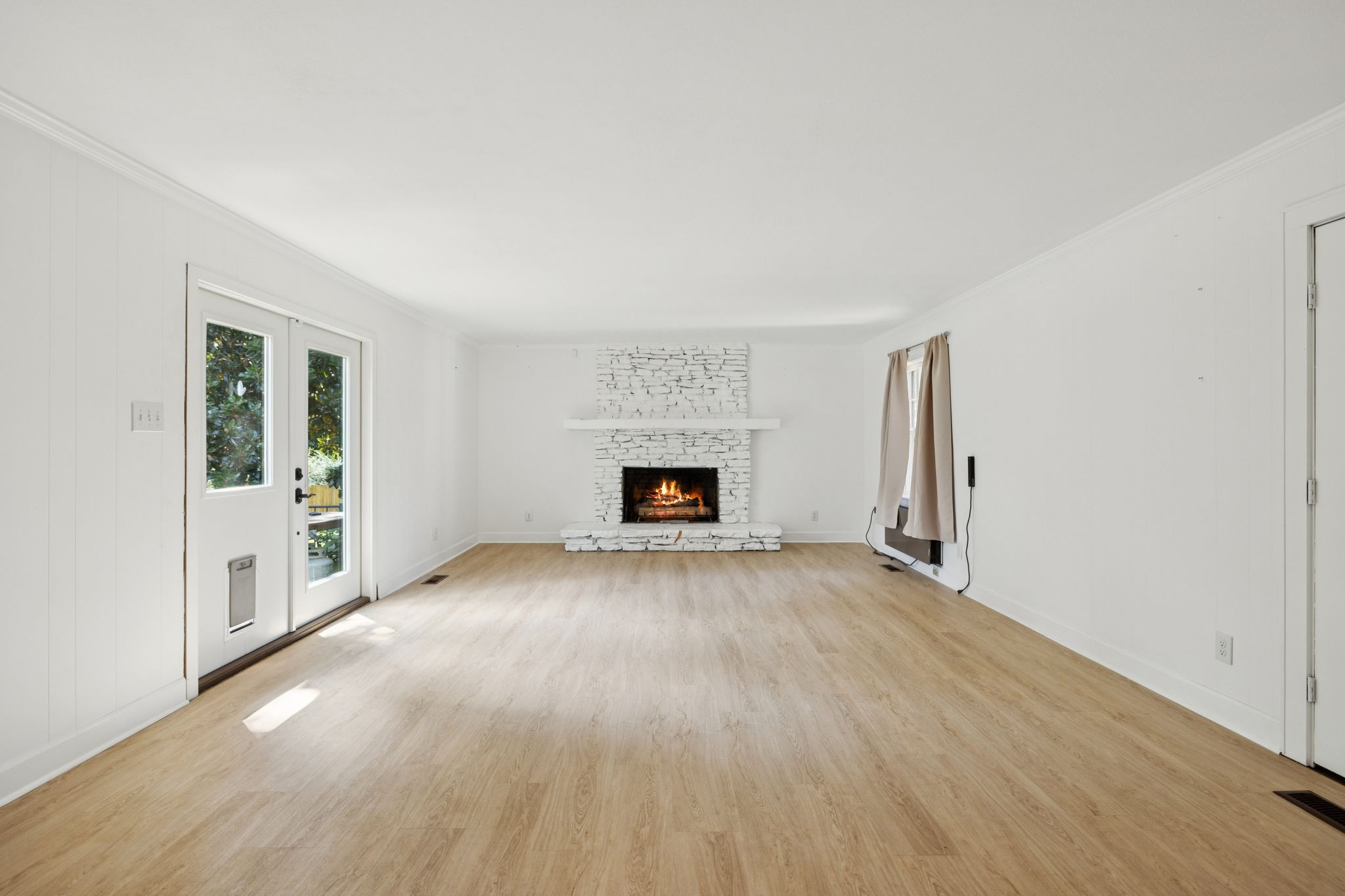 527 East Madison Street Pulaski, TN 38478 - Photo 41 of 74 a view of an empty room with a fireplace and a window