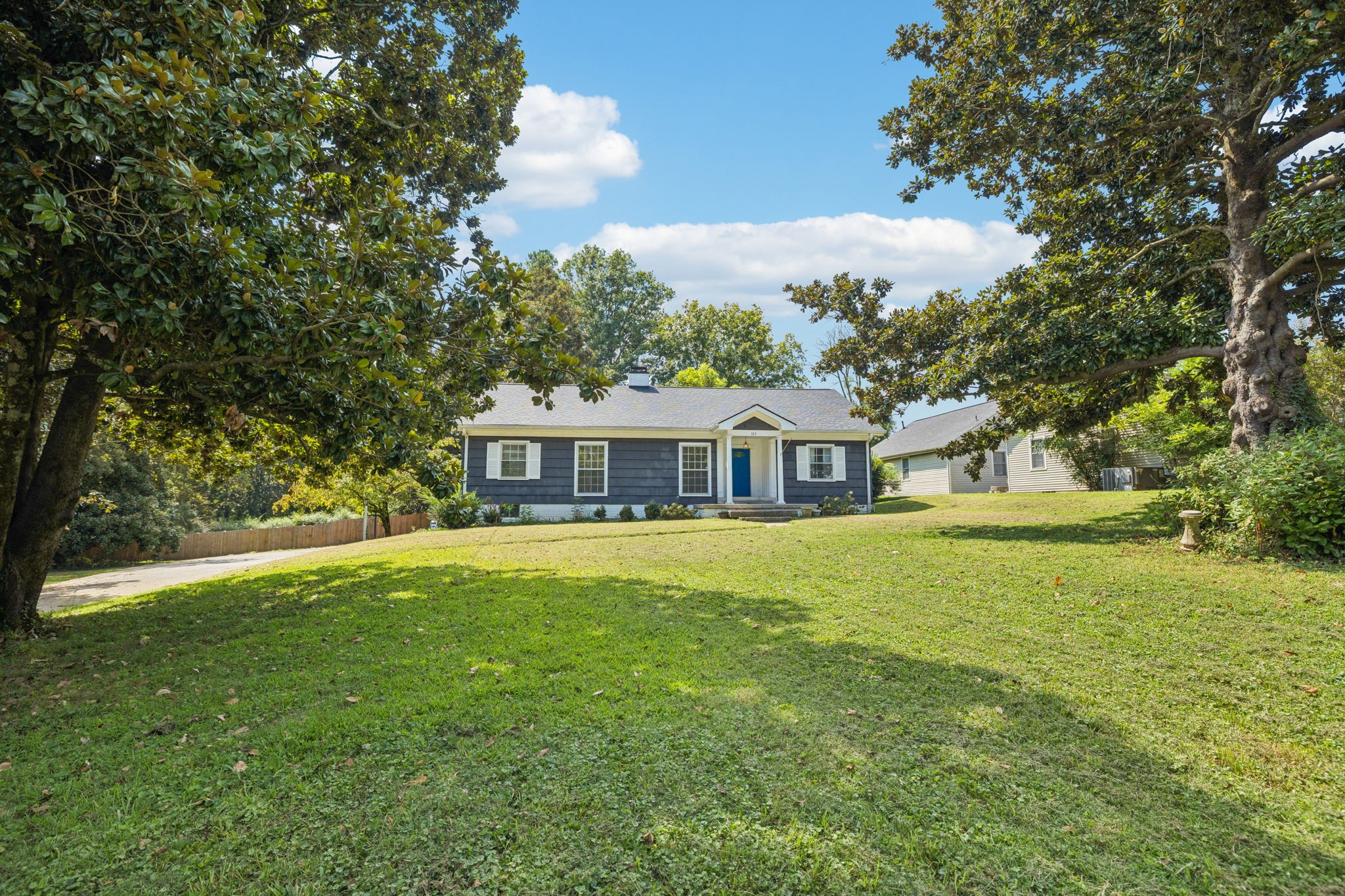 527 East Madison Street Pulaski, TN 38478 - Photo 5 of 74 a front view of a house with a garden