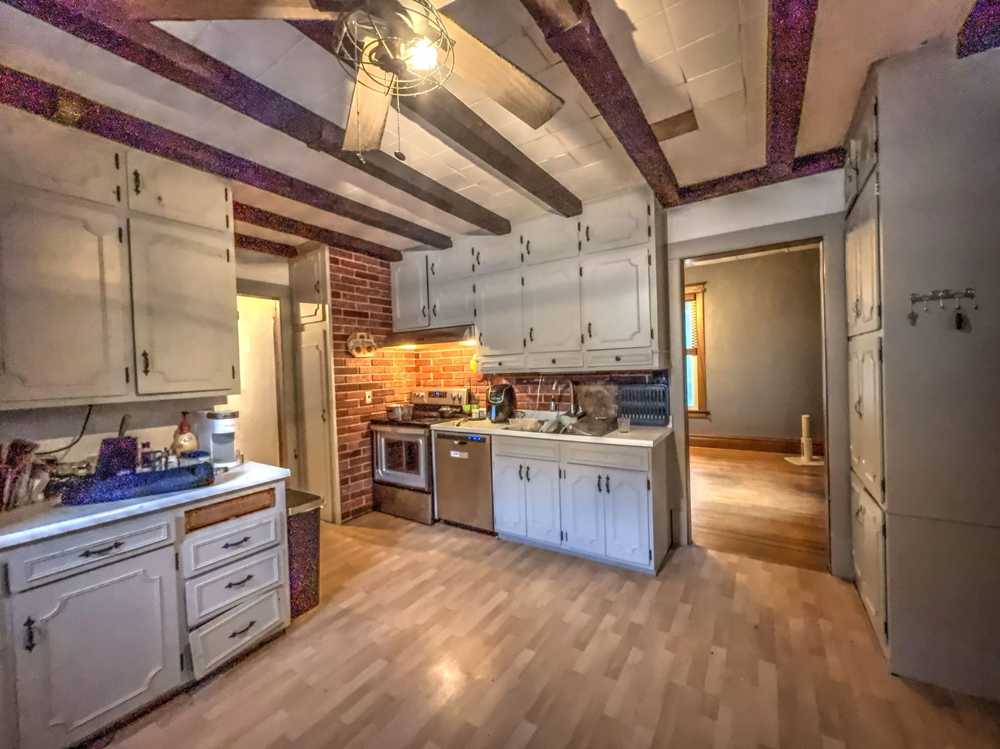 533 South 4th Street Watseka, IL 60970 - Photo 22 of 24 a kitchen with stainless steel appliances kitchen island granite countertop a refrigerator a sink dishwasher and wooden cabinets with wooden floor