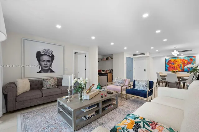 a living room with furniture a rug and a flat screen tv