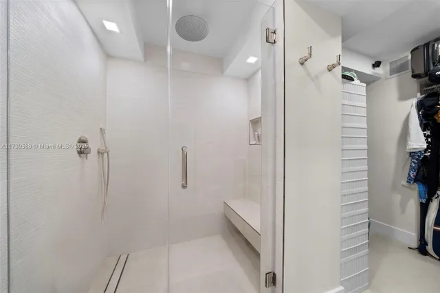 a bathroom with a shower and a sink