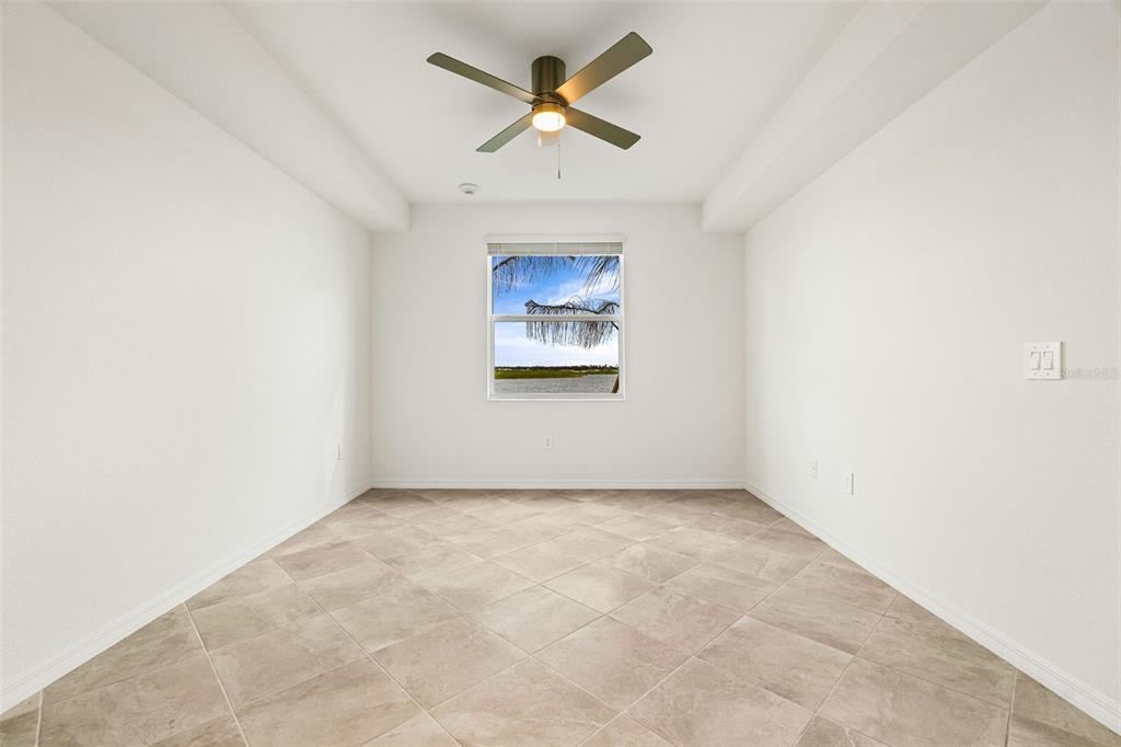 19140 Scallop Loop, Unit 105 Lakewood Ranch, FL 34211 - Photo 16 of 37 an empty room with chandelier fan and windows