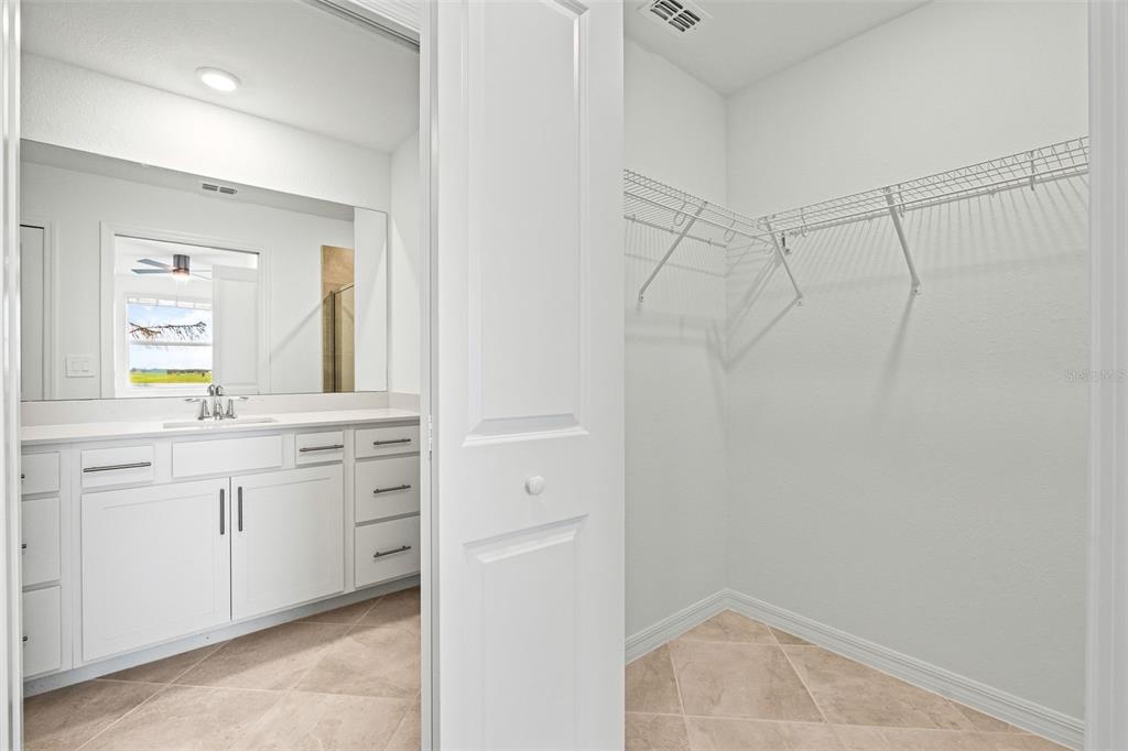19140 Scallop Loop, Unit 105 Lakewood Ranch, FL 34211 - Photo 18 of 37 a bathroom with a granite countertop sink and a mirror