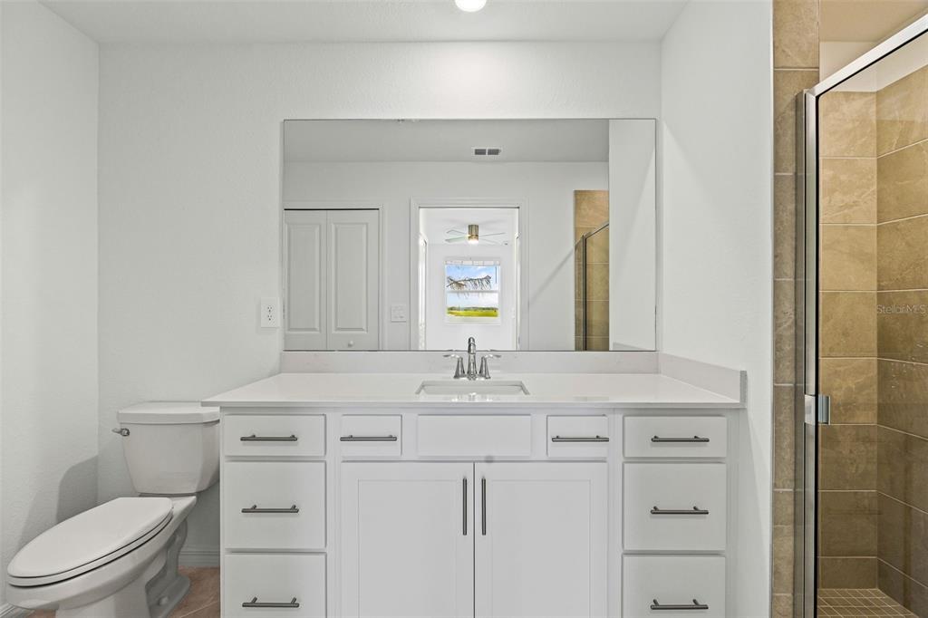 19140 Scallop Loop, Unit 105 Lakewood Ranch, FL 34211 - Photo 20 of 37 a bathroom with a sink vanity toilet and mirror
