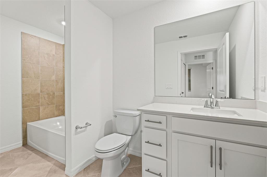 19140 Scallop Loop, Unit 105 Lakewood Ranch, FL 34211 - Photo 21 of 37 a bathroom with a sink a toilet and shower