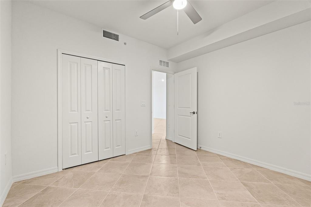 19140 Scallop Loop, Unit 105 Lakewood Ranch, FL 34211 - Photo 23 of 37 an empty room with a ceiling fan window and a bathroom