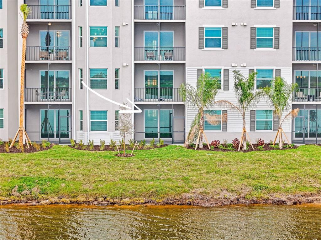 19140 Scallop Loop, Unit 105 Lakewood Ranch, FL 34211 - Photo 27 of 37 a front view of a building with a garden