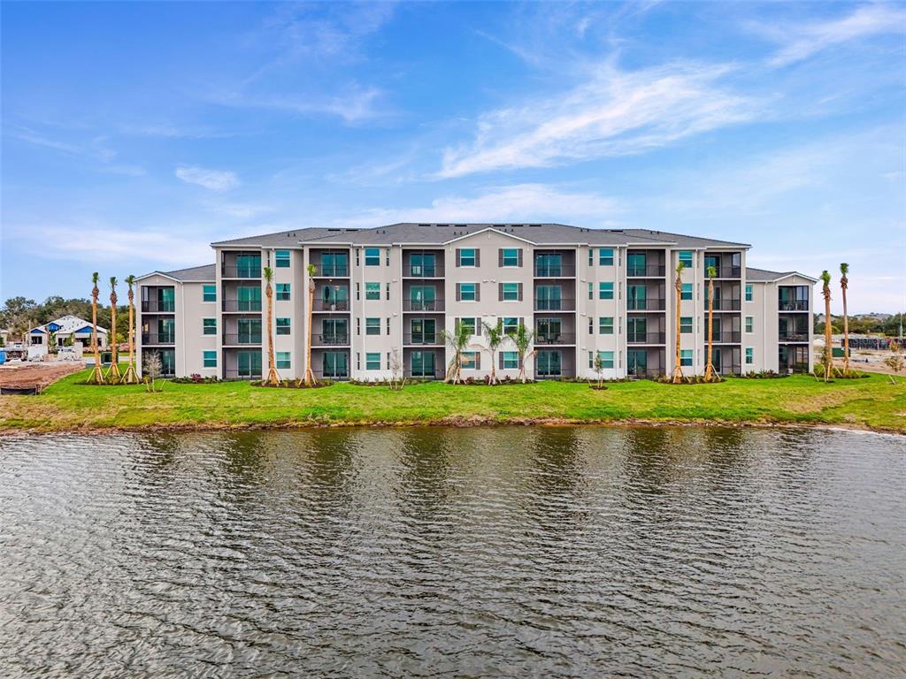 19140 Scallop Loop, Unit 105 Lakewood Ranch, FL 34211 - Photo 28 of 37 a view of building with a garden