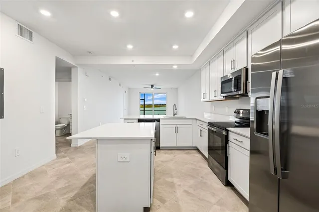 a kitchen with a sink cabinets and window