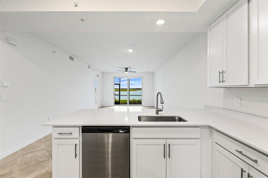 19140 Scallop Loop, Unit 105 Lakewood Ranch, FL 34211 - Photo 8 of 37 a kitchen with a sink cabinets and window