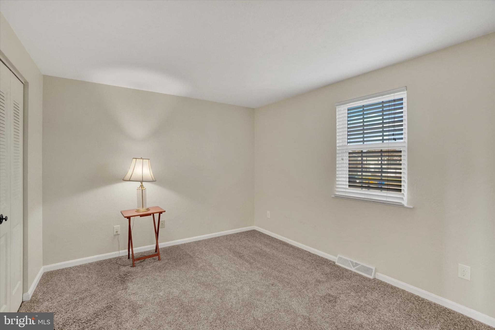 2270 Seneca Drive York, PA 17408 - Photo 13 of 28 a view of an empty room with a window and a lamp