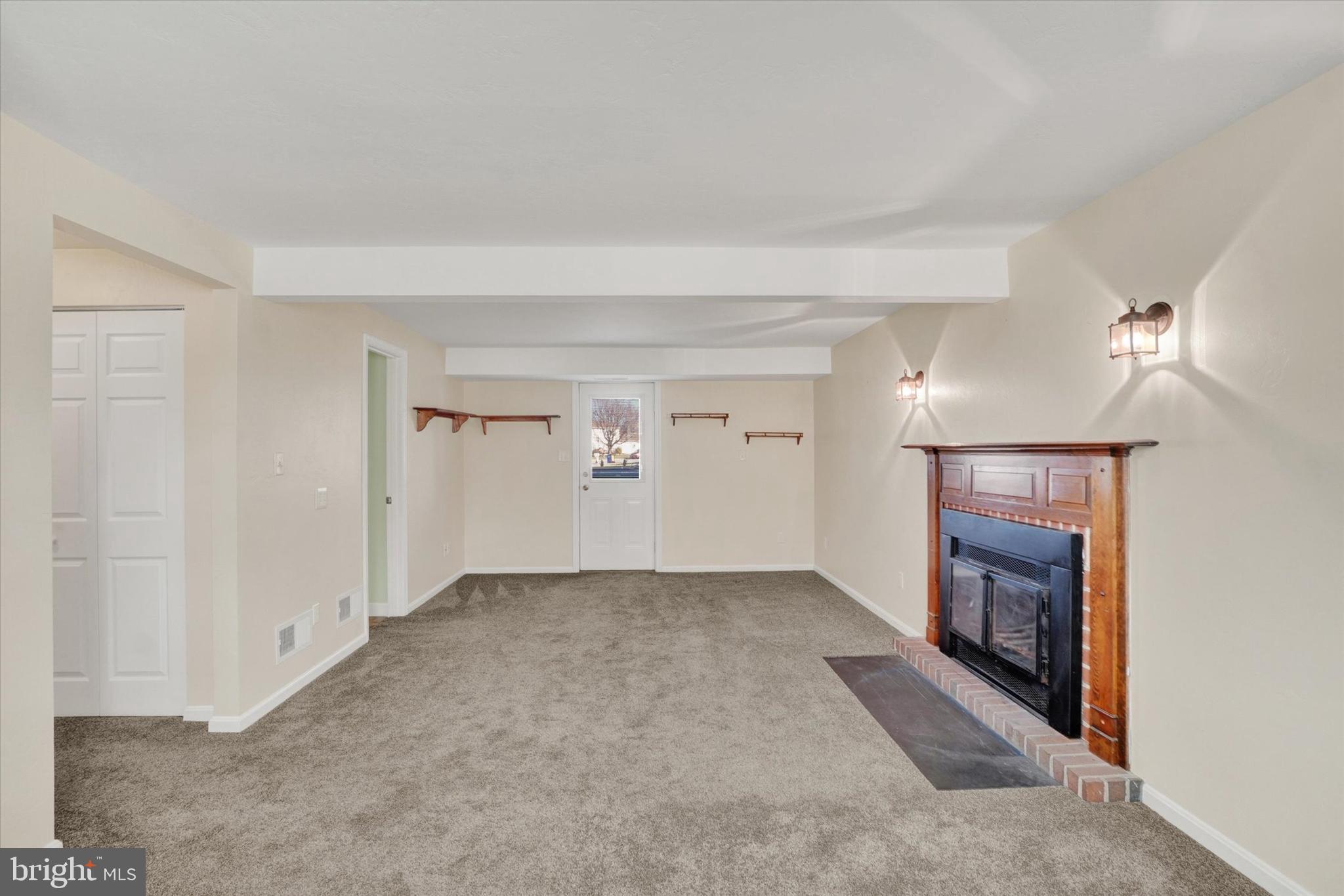 2270 Seneca Drive York, PA 17408 - Photo 19 of 28 an empty room with a fireplace and window