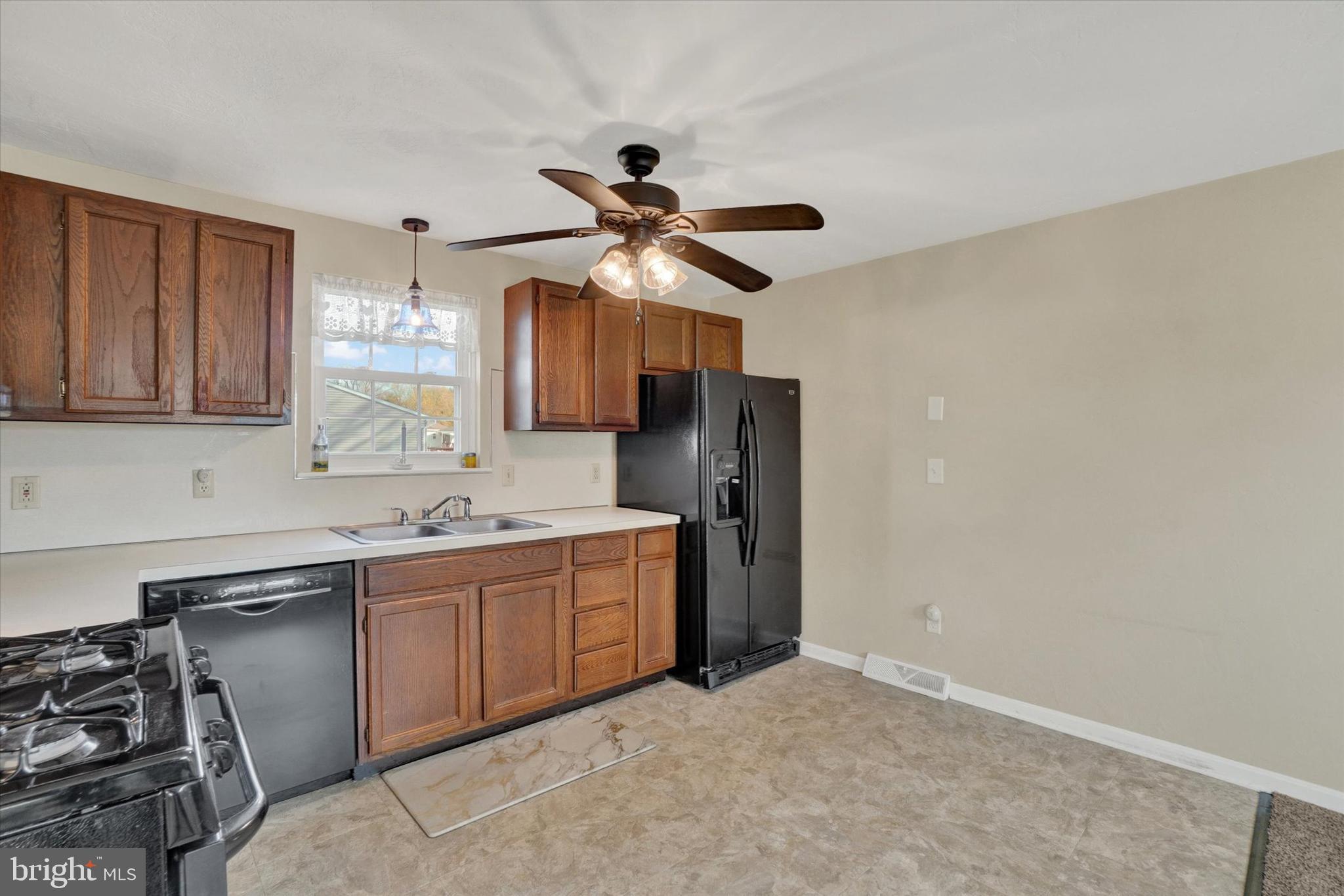 2270 Seneca Drive York, PA 17408 - Photo 8 of 28 a kitchen with stainless steel appliances a sink a stove a refrigerator cabinets and a dining table