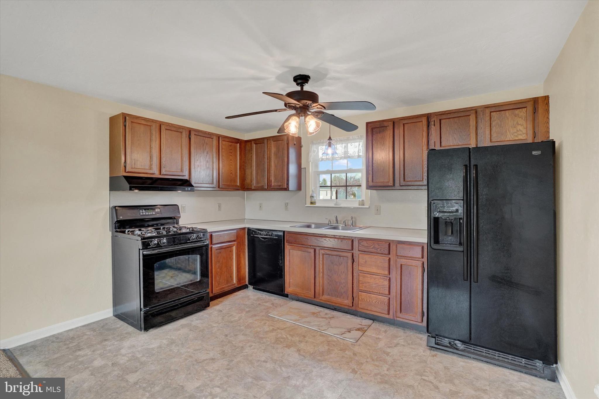 2270 Seneca Drive York, PA 17408 - Photo 9 of 28 a kitchen with granite countertop a refrigerator stove top oven and sink