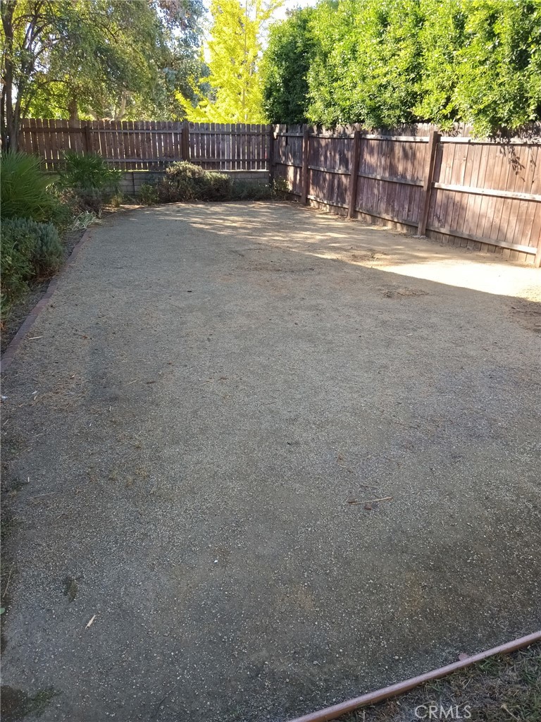 6656 Columbus Avenue Van Nuys, CA 91405 - Photo 16 of 21 a view of street next to a yard with large trees