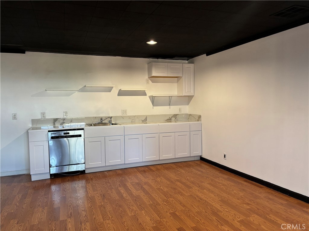 6656 Columbus Avenue Van Nuys, CA 91405 - Photo 19 of 21 a kitchen with a sink and cabinets