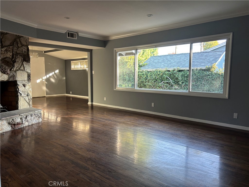 6656 Columbus Avenue Van Nuys, CA 91405 - Photo 20 of 21 a view of an empty room with wooden floor and a window