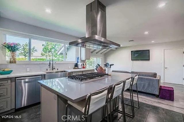6656 Columbus Avenue Van Nuys, CA 91405 - Photo 5 of 21 a kitchen with stainless steel appliances granite countertop a stove a kitchen island a dining table and chairs