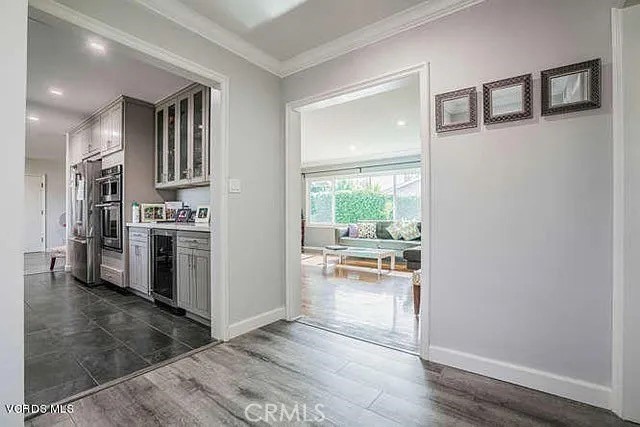 6656 Columbus Avenue Van Nuys, CA 91405 - Photo 6 of 21 a kitchen with stainless steel appliances a refrigerator and wooden floor