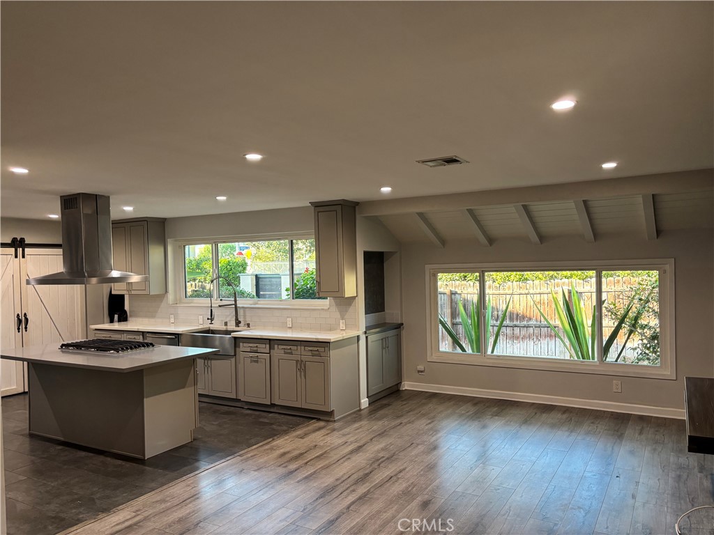 6656 Columbus Avenue Van Nuys, CA 91405 - Photo 9 of 21 a large kitchen with stainless steel appliances granite countertop a stove and a large window