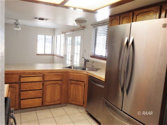 200 Washington Way Ridgecrest, CA 93555 - Photo 11 of 35 a kitchen with stainless steel appliances granite countertop a refrigerator and a sink