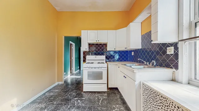a kitchen with a sink stove and refrigerator