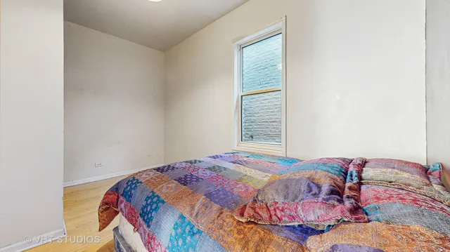 a bedroom with a bed and a window