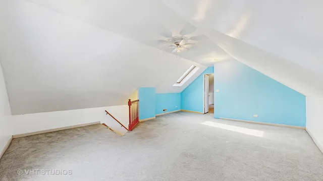 an empty room with a ceiling fan and entryway