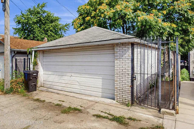 a yellow house with a tree in the background
