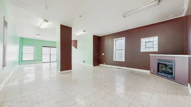 a view of an empty room with a fireplace