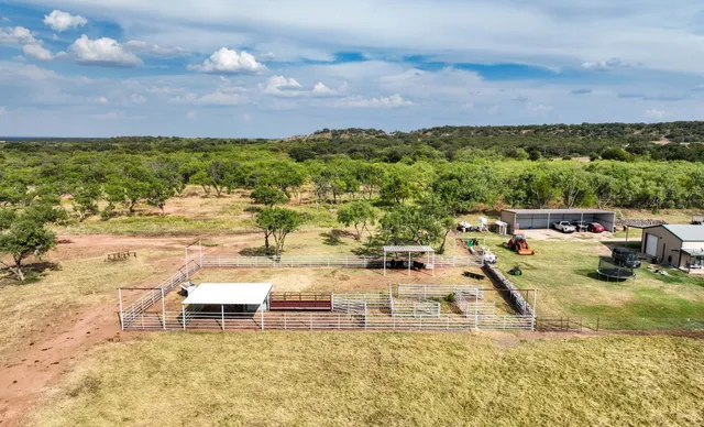 a view of a lake with lawn chairs