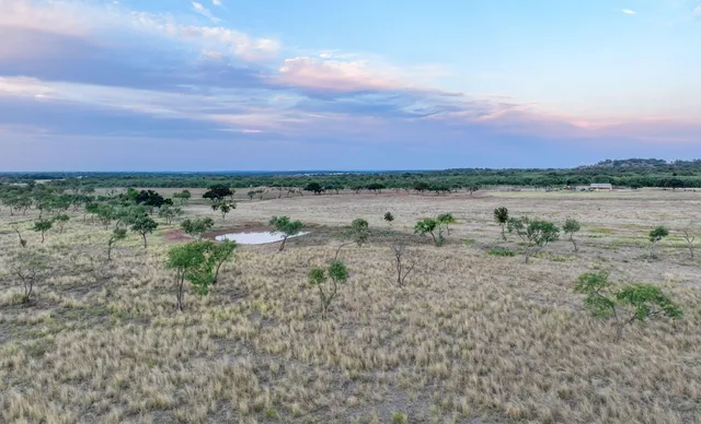 a view of a lake with houses in the back