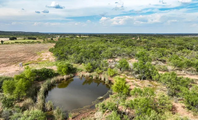an aerial view of residential building and lake