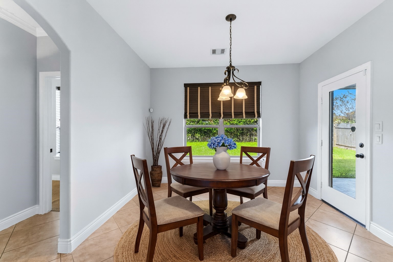 25327 Oak Knot Drive Spring, TX 77389 - Photo 11 of 32 a dining room with furniture a chandelier and wooden floor