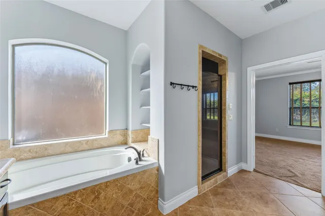 a bathroom with a tub and a shower