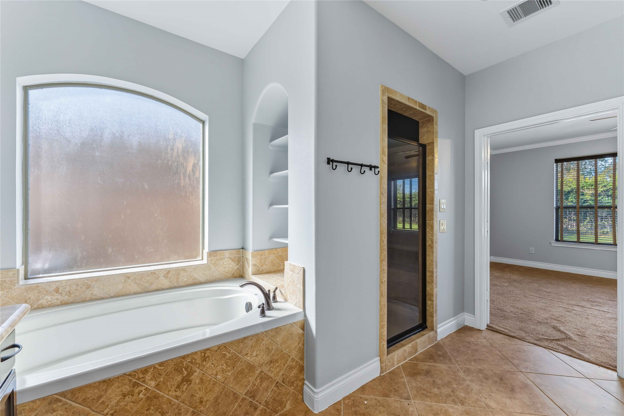 25327 Oak Knot Drive Spring, TX 77389 - Photo 15 of 32 a bathroom with a tub and a shower