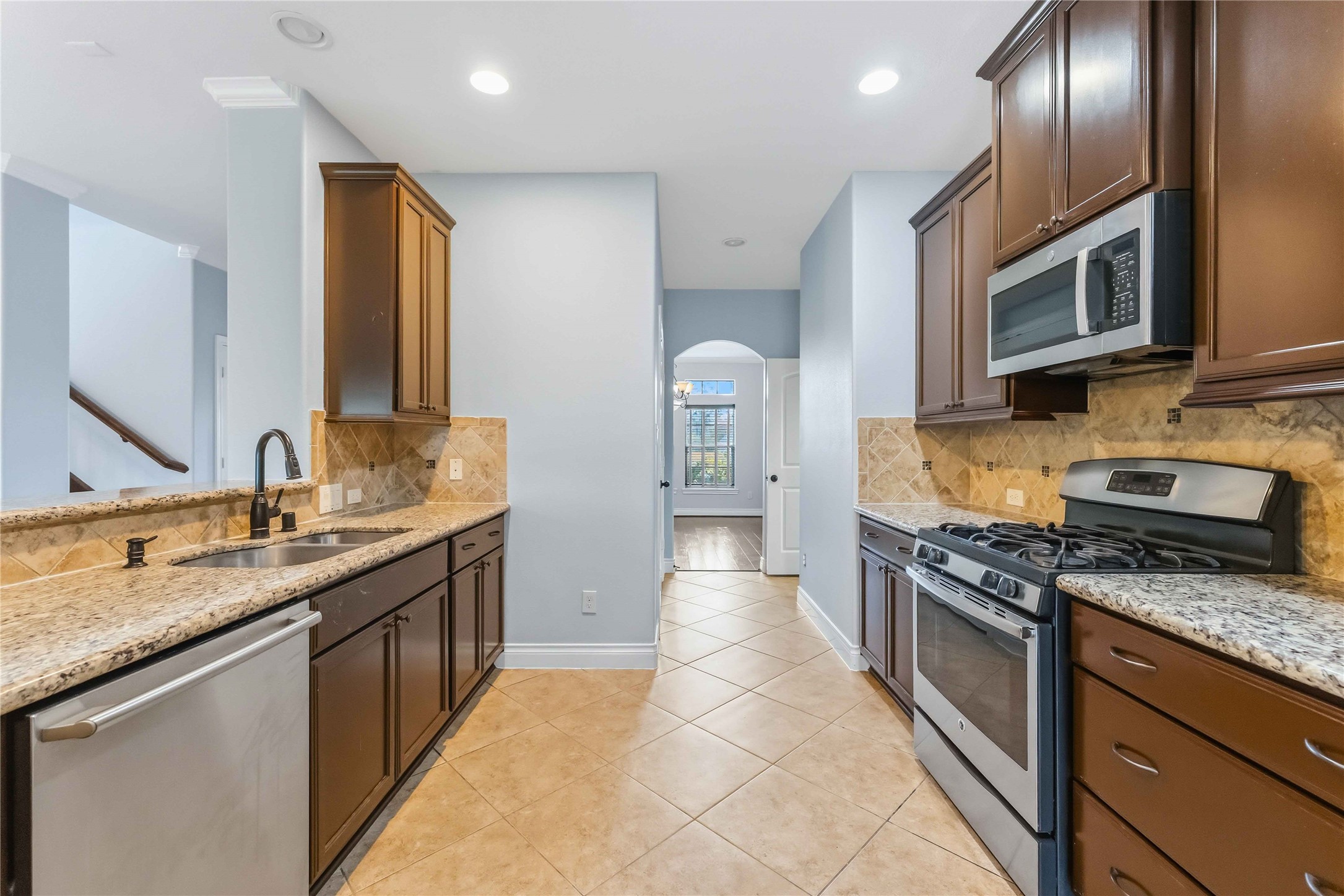 25327 Oak Knot Drive Spring, TX 77389 - Photo 20 of 32 a kitchen with stainless steel appliances granite countertop a sink stove and cabinets
