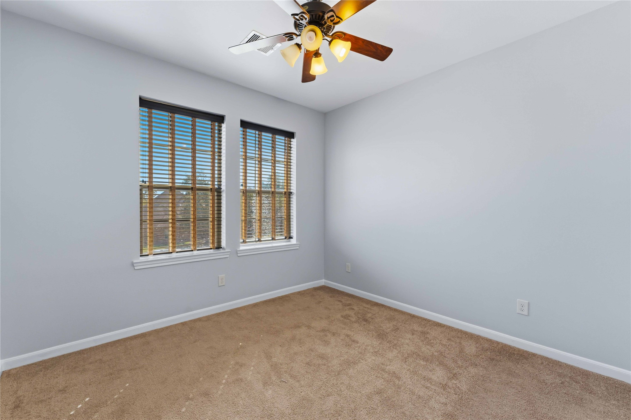 25327 Oak Knot Drive Spring, TX 77389 - Photo 26 of 32 an empty room with windows and a chandelier fan