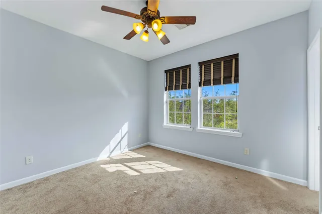 an empty room with a empty space and a ceiling fan
