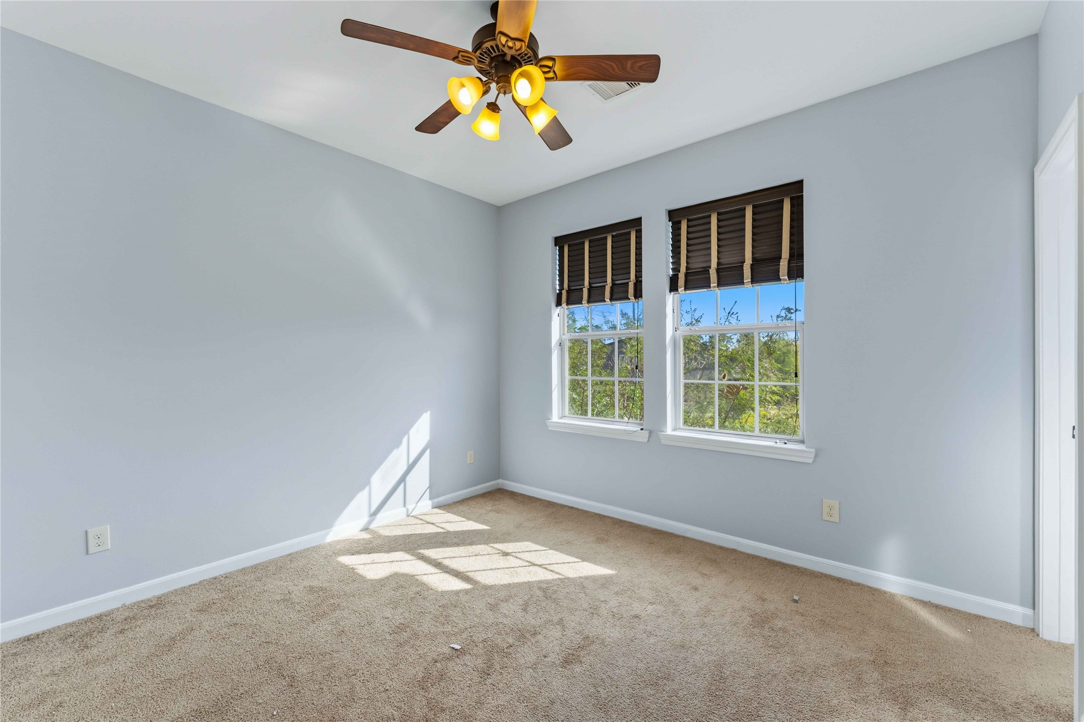 25327 Oak Knot Drive Spring, TX 77389 - Photo 28 of 32 an empty room with windows and chandelier fan
