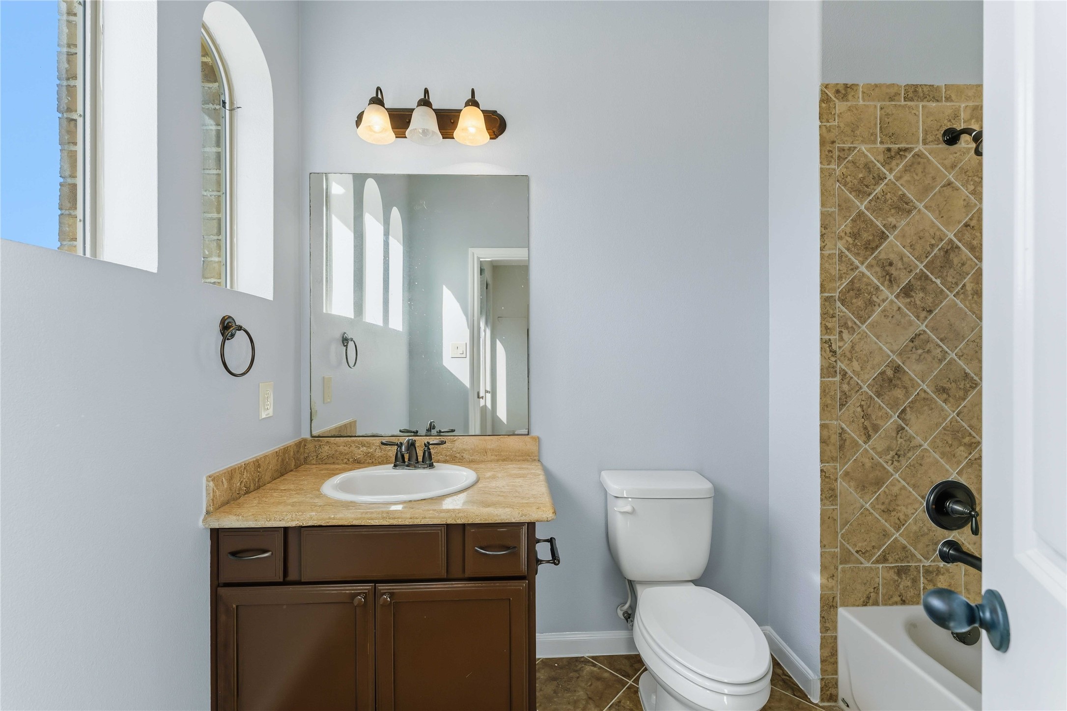 25327 Oak Knot Drive Spring, TX 77389 - Photo 30 of 32 a bathroom with a sink a toilet and shower
