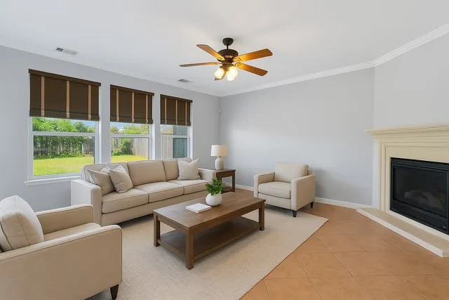 a living room with furniture a chandelier and a fireplace