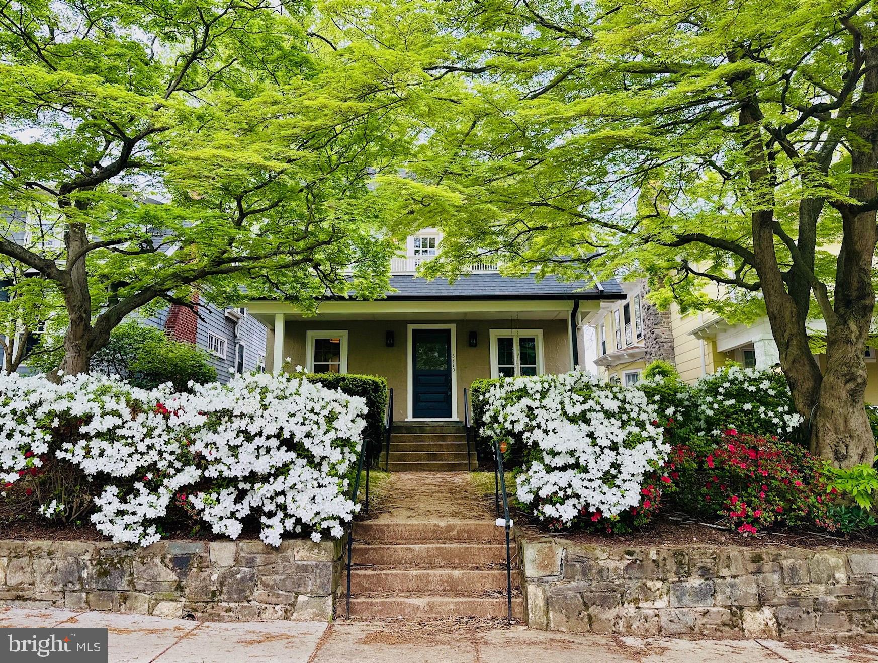 3410 Morrison Street Northwest Washington, DC 20015 - Photo 1 of 71 a front view of a house with lots of flowers planted