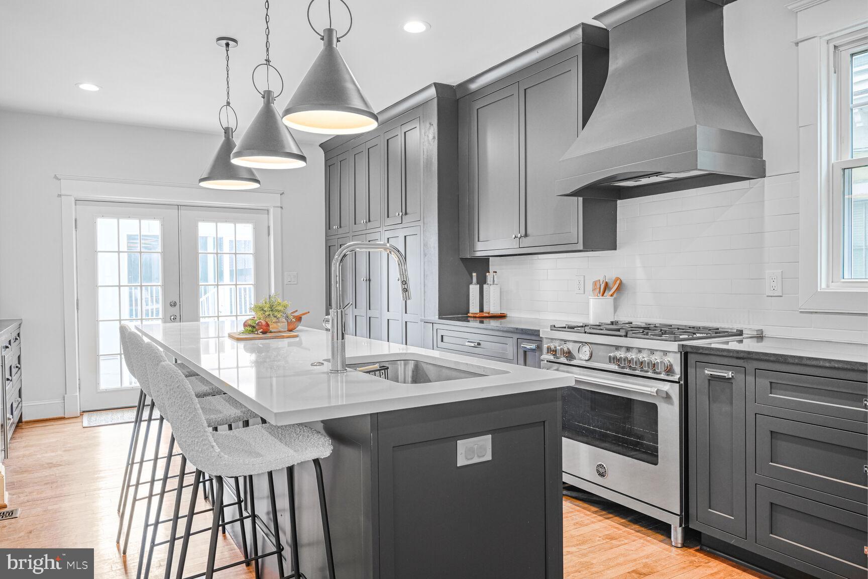 3410 Morrison Street Northwest Washington, DC 20015 - Photo 15 of 71 a kitchen with stainless steel appliances granite countertop a sink a stove and chairs