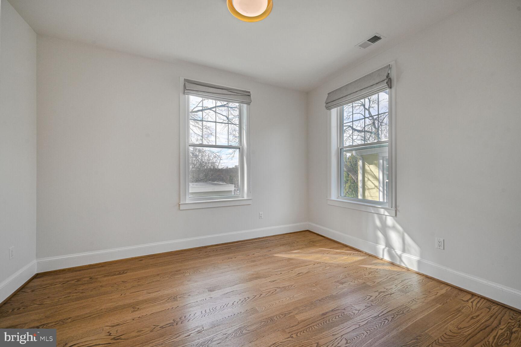 3410 Morrison Street Northwest Washington, DC 20015 - Photo 30 of 71 a view of an empty room with wooden floor and a window